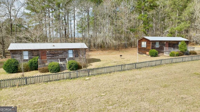 view of yard with covered porch and a fenced front yard