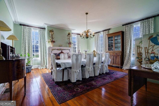 dining space featuring a chandelier, hardwood / wood-style floors, and crown molding