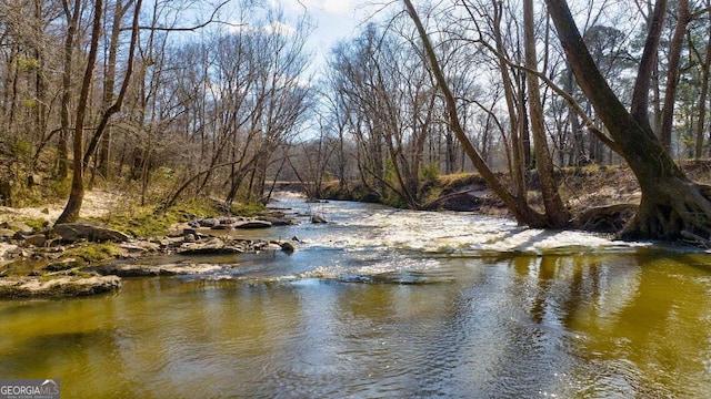 property view of water featuring a forest view