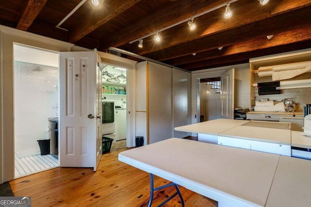 kitchen featuring wooden ceiling, hardwood / wood-style flooring, beam ceiling, and washer / dryer