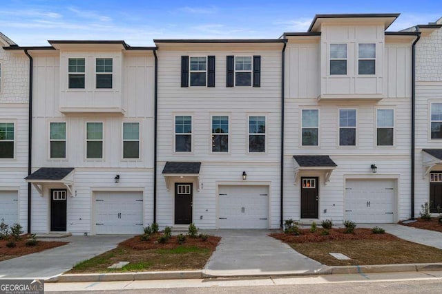 townhome / multi-family property featuring a garage and board and batten siding