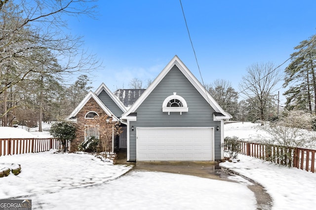 view of front of house with a garage and fence