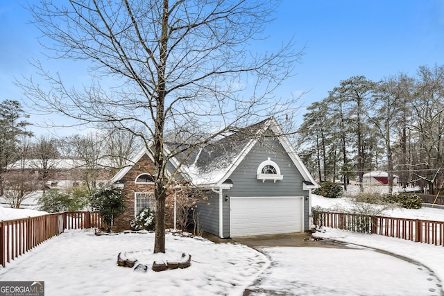 view of front of house with a garage and fence