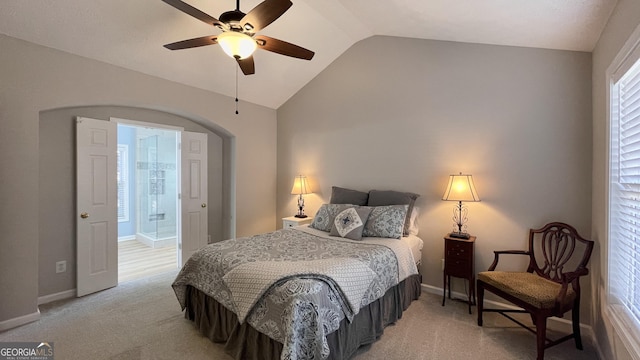 bedroom with light carpet, baseboards, arched walkways, and lofted ceiling