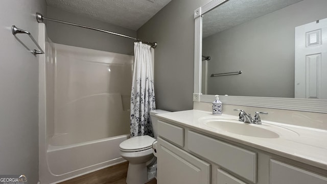 bathroom featuring shower / tub combo, toilet, wood finished floors, a textured ceiling, and vanity