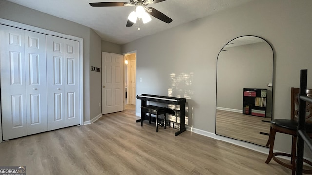 home office featuring ceiling fan, wood finished floors, and baseboards