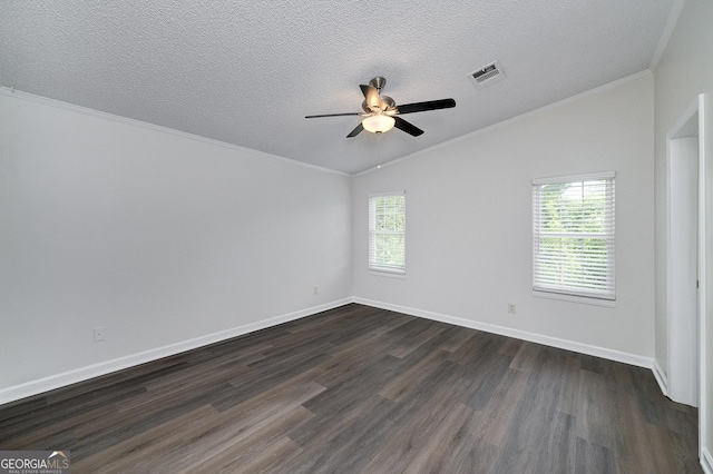 empty room featuring a healthy amount of sunlight, crown molding, a textured ceiling, and dark wood-style flooring