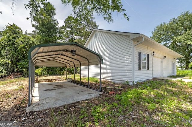 view of side of home with a garage and a detached carport