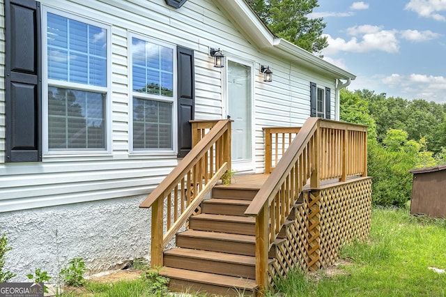 entrance to property featuring a wooden deck