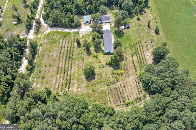 drone / aerial view with a wooded view