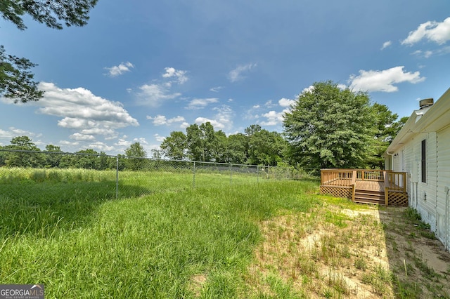 view of yard with fence and a wooden deck