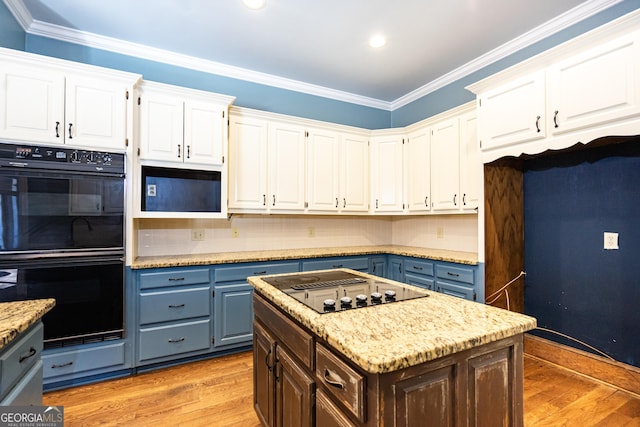 kitchen with ornamental molding, white cabinets, light wood-style flooring, and black appliances