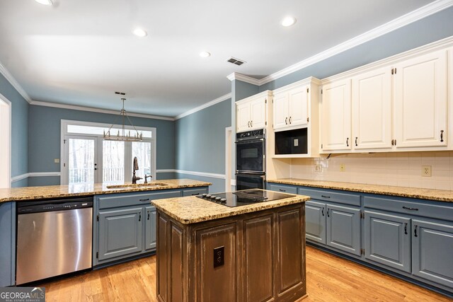 kitchen with gray cabinetry, a sink, white cabinetry, visible vents, and black appliances