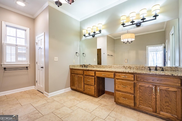 bathroom featuring a healthy amount of sunlight, crown molding, and a sink