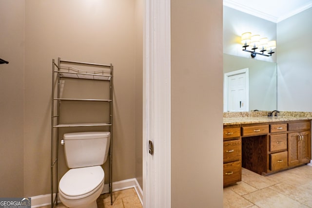 bathroom featuring ornamental molding, baseboards, vanity, and toilet