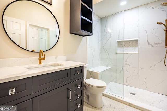 bathroom featuring vanity, a marble finish shower, toilet, and recessed lighting