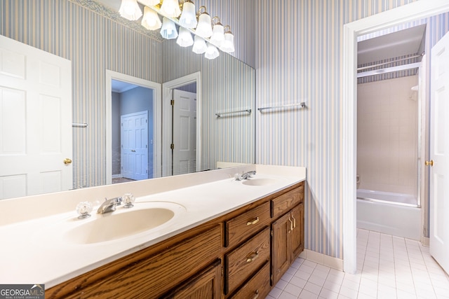 full bath featuring tile patterned floors, a sink, and wallpapered walls