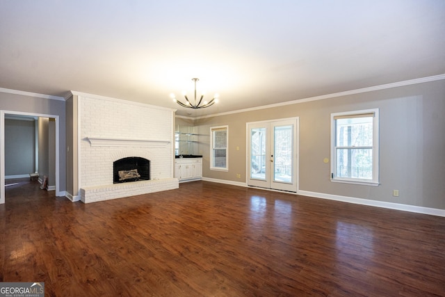 unfurnished living room with baseboards, a fireplace, ornamental molding, and dark wood-style flooring