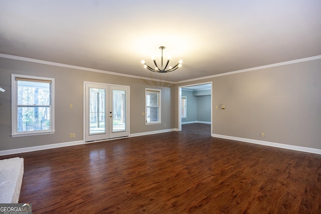 unfurnished living room featuring dark wood-type flooring, french doors, baseboards, and an inviting chandelier