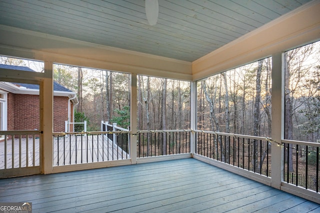 unfurnished sunroom with plenty of natural light and wood ceiling