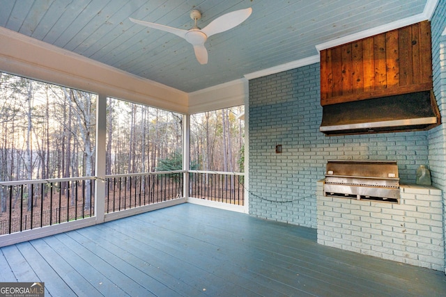 unfurnished sunroom featuring a ceiling fan and wooden ceiling