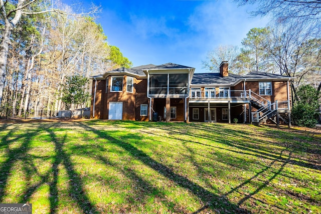 back of house with a yard, brick siding, stairway, and a sunroom