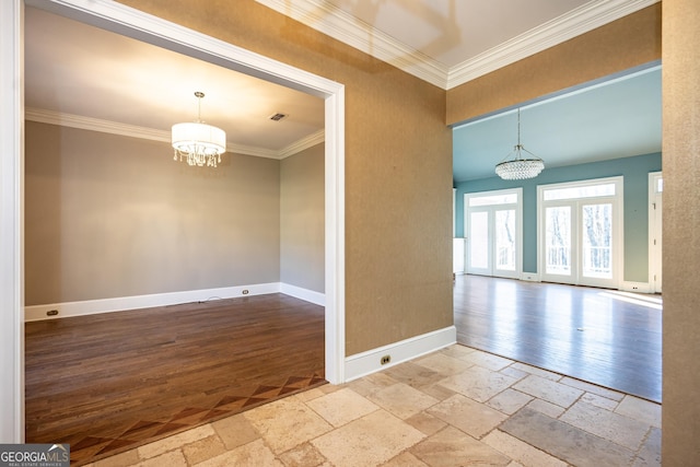 unfurnished room with a chandelier, stone tile floors, visible vents, baseboards, and crown molding