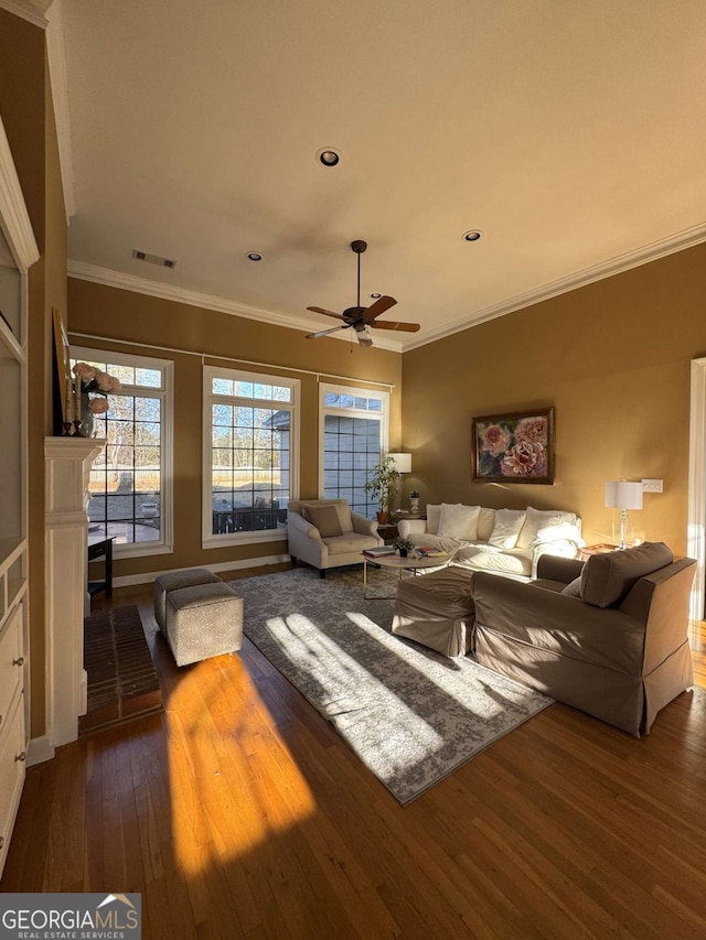 living area with ceiling fan, hardwood / wood-style flooring, recessed lighting, visible vents, and crown molding