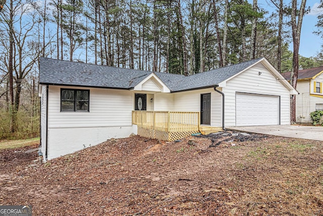 ranch-style home with an attached garage, concrete driveway, and roof with shingles