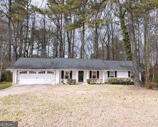 ranch-style home featuring driveway and an attached garage