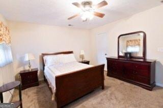 bedroom featuring a ceiling fan and light colored carpet