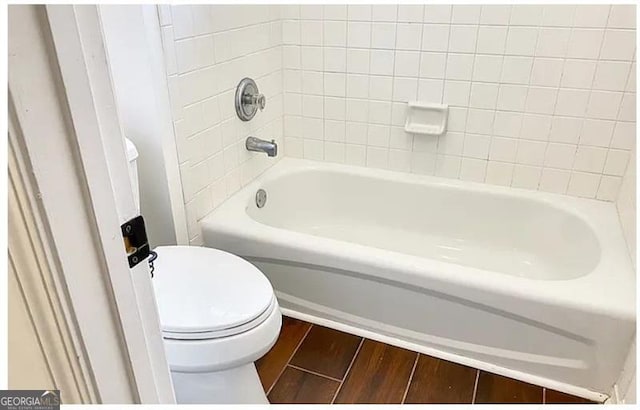 full bathroom featuring toilet and wood finished floors