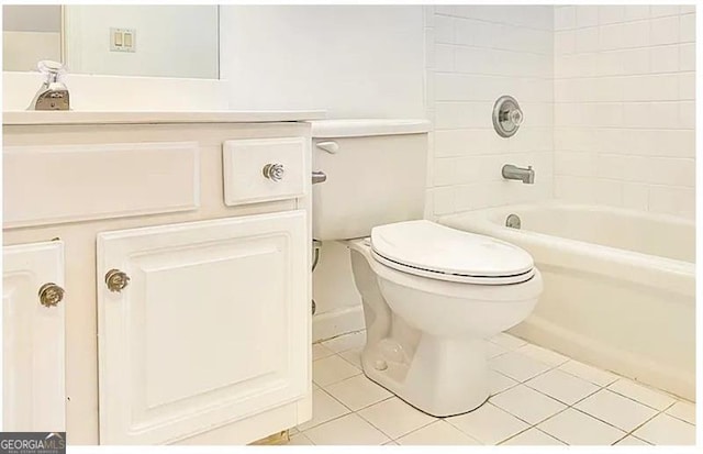 bathroom featuring toilet,  shower combination, vanity, and tile patterned floors