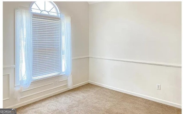 carpeted empty room featuring a healthy amount of sunlight