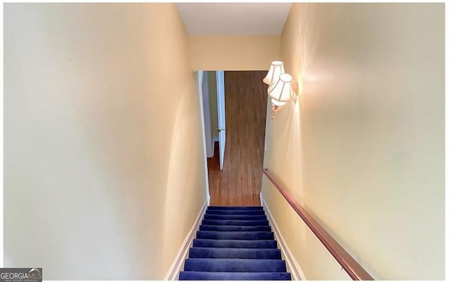 staircase featuring baseboards