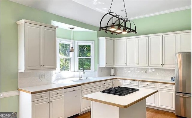 kitchen with dishwasher, freestanding refrigerator, black gas cooktop, light countertops, and a sink