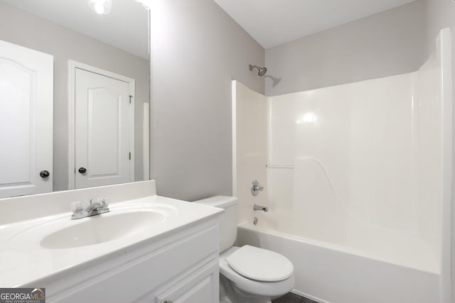 bathroom featuring bathtub / shower combination, vanity, and toilet