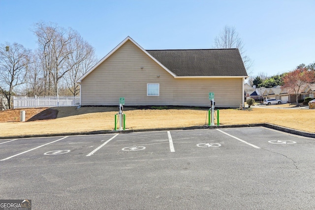 uncovered parking lot featuring fence