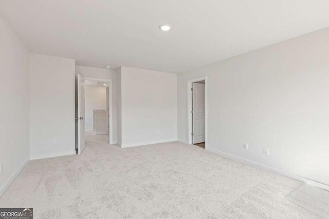 unfurnished bedroom with recessed lighting, baseboards, and light colored carpet