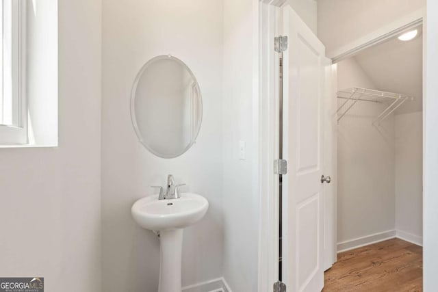 bathroom featuring baseboards and wood finished floors