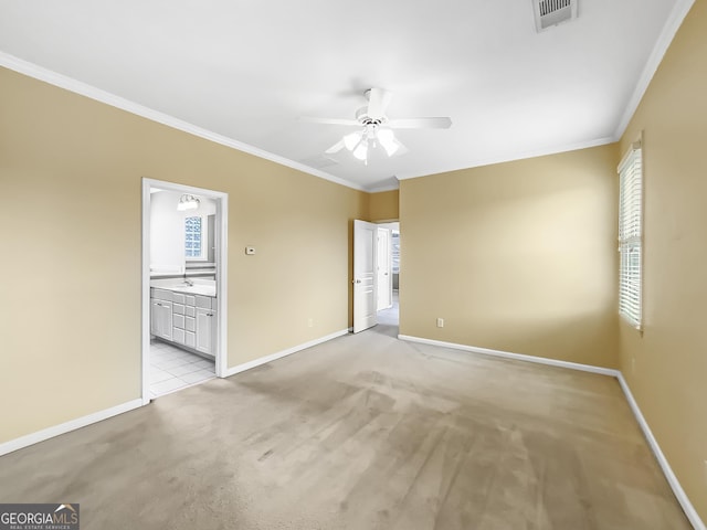 unfurnished room with baseboards, ornamental molding, visible vents, and light colored carpet