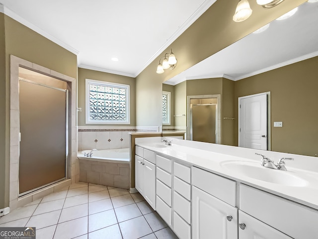 full bathroom featuring a garden tub, a shower stall, a sink, and tile patterned floors