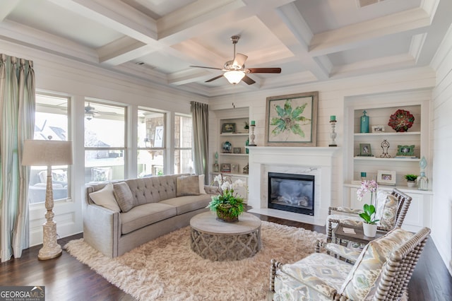 living area featuring ceiling fan, coffered ceiling, dark wood finished floors, and beam ceiling