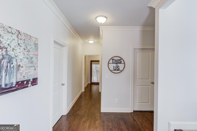 hallway featuring dark wood-style flooring, crown molding, and baseboards