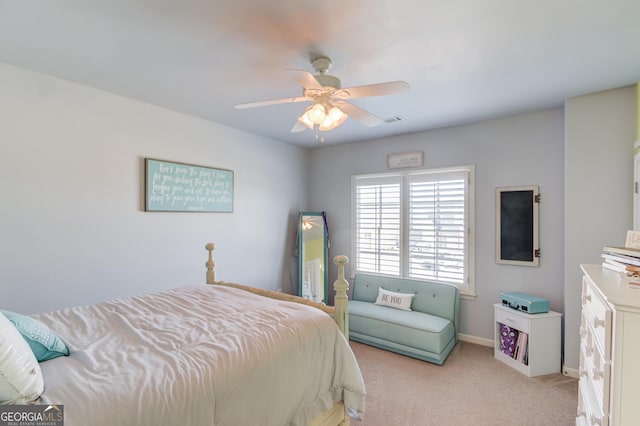 bedroom featuring baseboards, a ceiling fan, visible vents, and light colored carpet