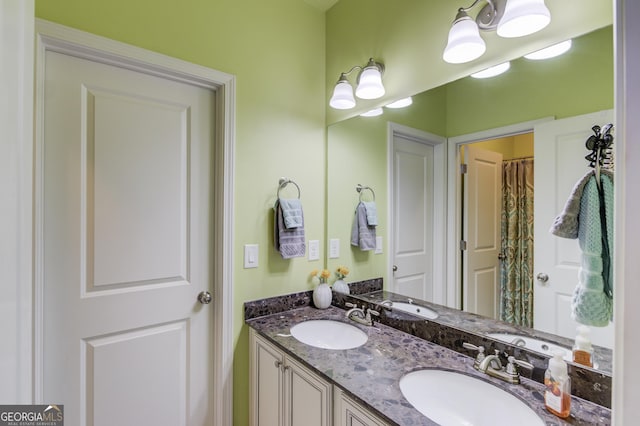 bathroom featuring a sink and double vanity