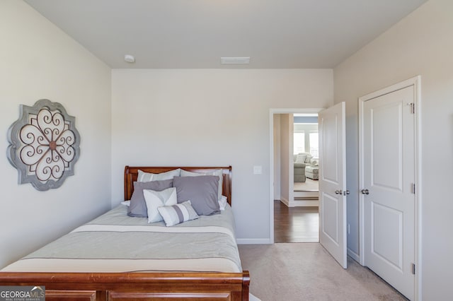 bedroom with carpet flooring, visible vents, and baseboards