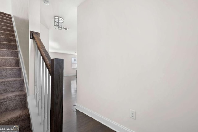 stairway featuring baseboards and wood finished floors