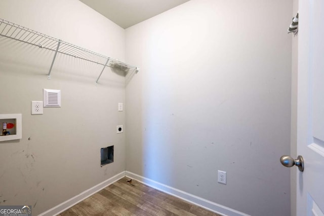 clothes washing area with hookup for an electric dryer, laundry area, washer hookup, wood finished floors, and baseboards