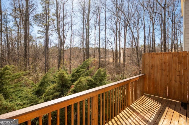 wooden deck featuring a forest view